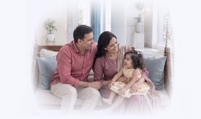 Couple seating on a sofa with their kid
